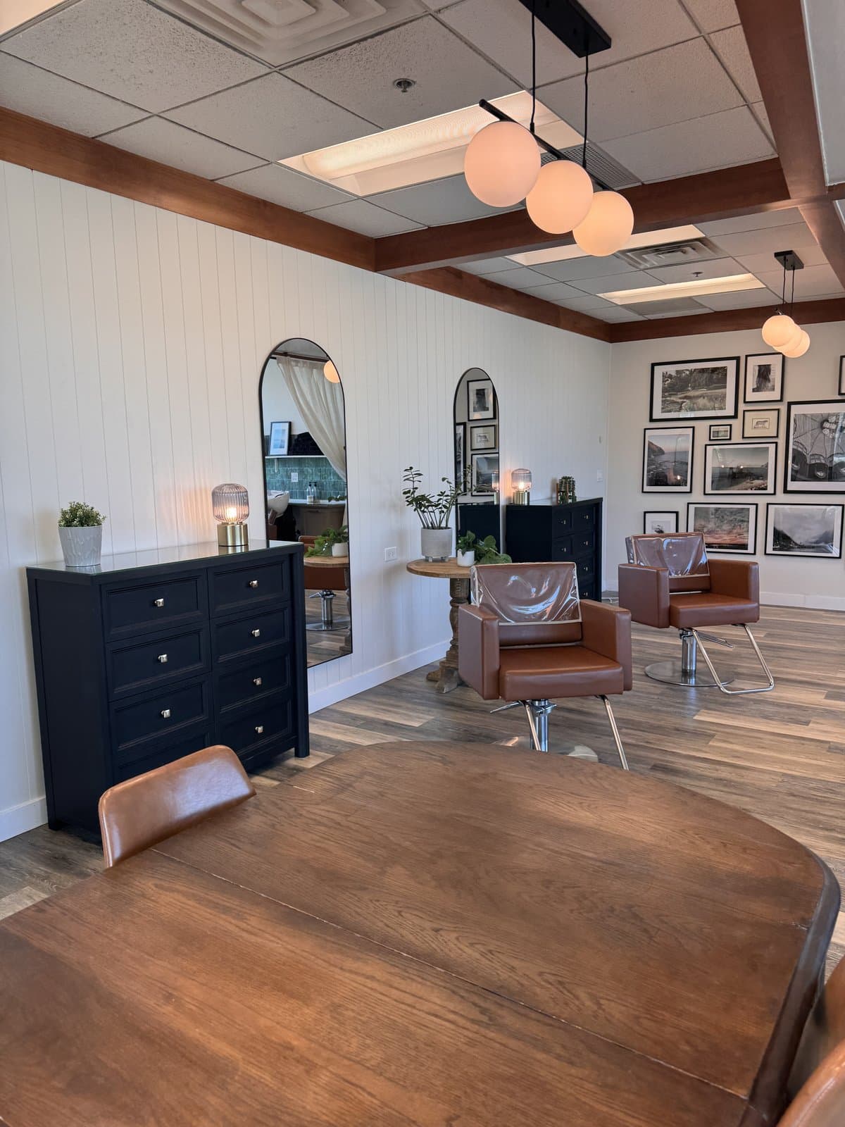 Lounge seating area with leather chairs and a vintage mirror